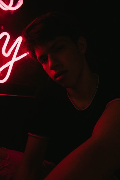 Red neon sign next to the person
